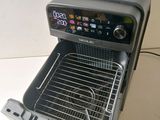 a toaster oven that is open on a table