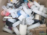 a cardboard box filled with plastic bottles and other items