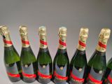 six bottles of champagne are lined up in a row on a table