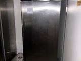 a stainless steel refrigerator in the corner of a room