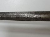 a close up of a knife on a white surface