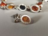 two bracelets with different colored stones on them
