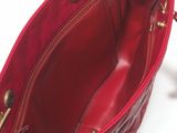 a red purse that is sitting on a white surface