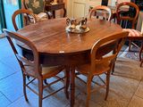 a table and chairs in a room with tile flooring