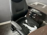 a black office chair sitting in front of a wooden desk