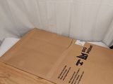 a box that is sitting on a bed next to a pillow