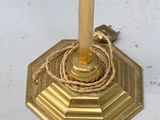 a gold candle holder with a rope wrapped around it