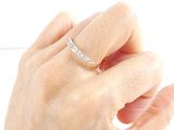a woman ' s hand that is holding a diamond ring