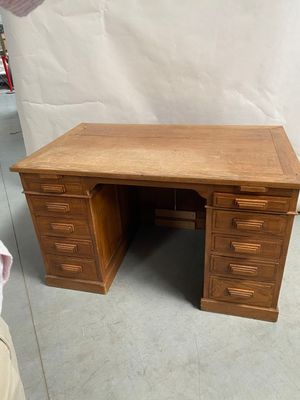 a wooden desk with two drawers and a drawer underneath it