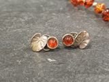 an image of a necklace and earrings with orange beads on a table