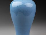 a blue vase that is sitting on a table