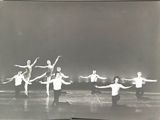 black and white photograph of a group of people in a dance pose