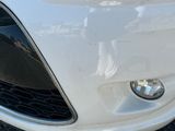 a close up of a car ' s front bumper and headlight