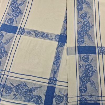 a close up of a blue and white table cloth on a table