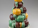 a ceramic sculpture of pumpkins stacked on top of each other