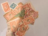 a pile of old postage stamps on a table