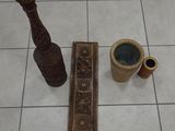 two vases and a pipe on the floor next to each other