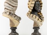 pair of busts of a man and a woman with a scarf on their heads