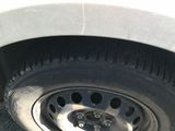 a close up of a tire on a white car