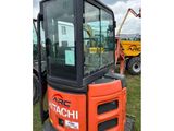a close up of a tractor with a crane in the background