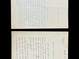 a close up of two papers on a black surface