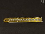 an image of a gold comb on a black background