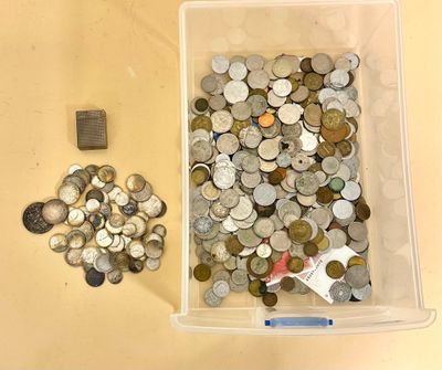 a lot of coins in a container on the table
