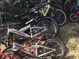 many bikes that are lined up outside of a house