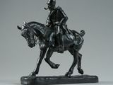 statue of a man riding a horse on a black base