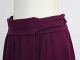 the back of a purple skirt with buttons on the waist