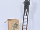 a wooden ladder with a clock on it next to a box