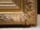 a picture of a picture of a gold frame on a table