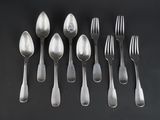 six silver spoons and six silver spoons on a black surface