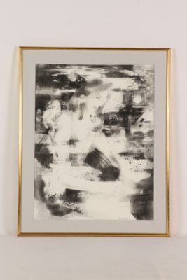 black and white abstract painting in a gold frame on a white wall
