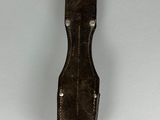 leather sheath for a knife on a white surface