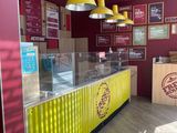 a yellow and red counter in the middle of a restaurant