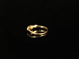 an image of a gold ring on a black surface