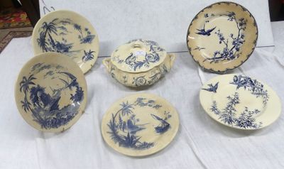 several blue and white china plates and bowls on a table