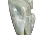 sculpture of a woman ' s head with a leaf on a wooden base