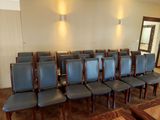 many chairs in a room with a mirror on the wall