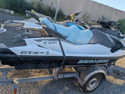 a white and black jet ski parked on a trailer