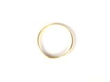 a gold ring on a white surface with a white background