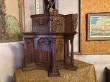 a wooden pulpit with a cross on top of it