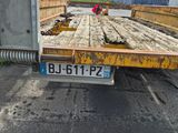 a flatbed truck that is parked in the parking lot