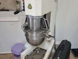 an image of a mixer and a suitcase in a room