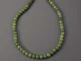 a green jade beaded necklace with a silver clasp