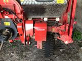 a red tractor that is parked on the side of the road