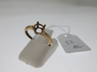 an image of a gold ring on a white surface with a price tag
