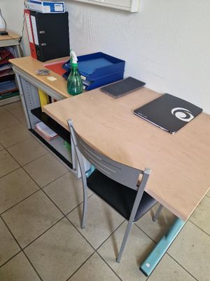 a desk with a laptop and a notebook on it