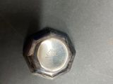 a metal knob that is sitting on a table